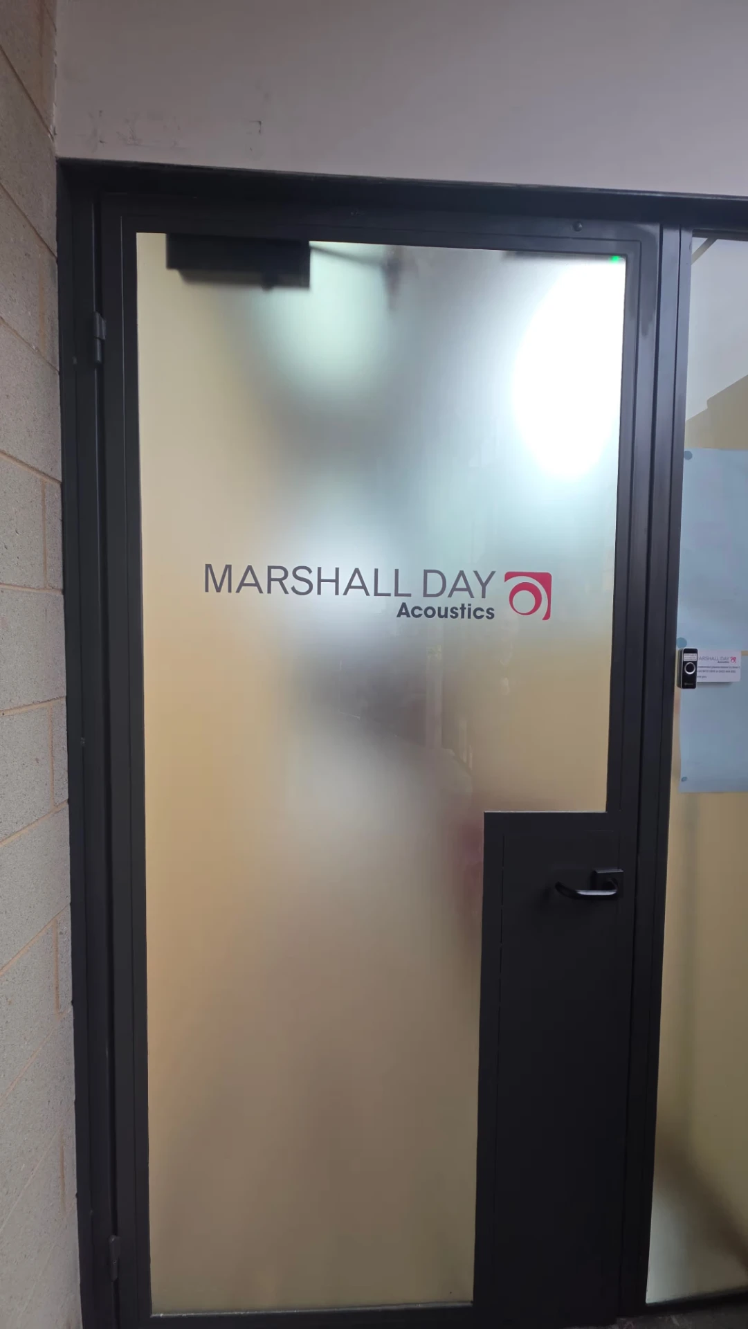 Frosted privacy film with company logo on a glass office entry door