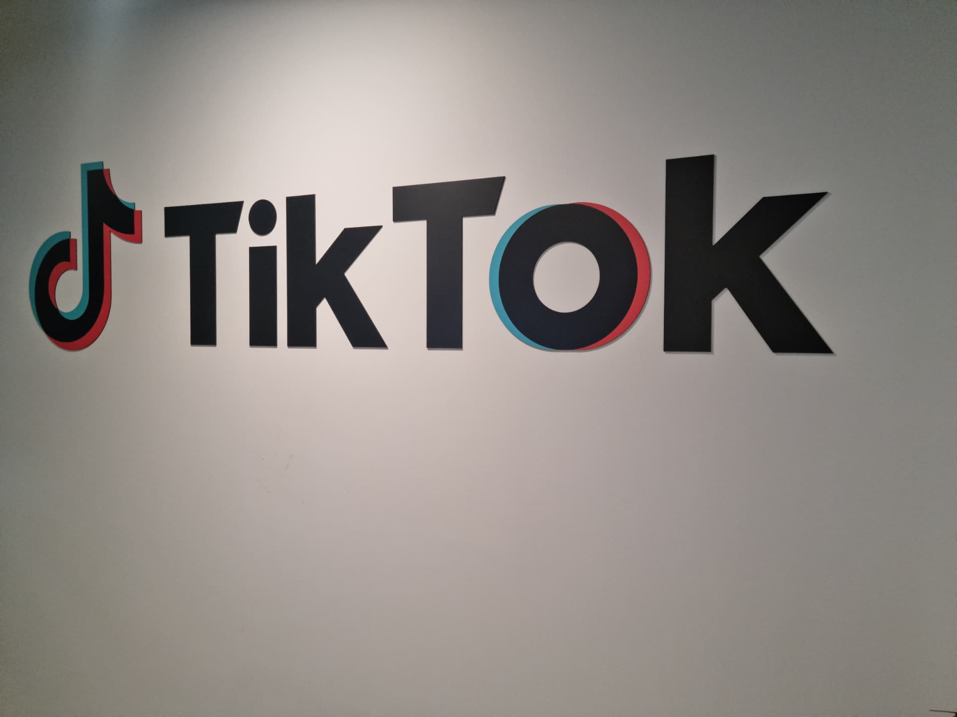 Large black vinyl wall lettering and logo installed on an office wall