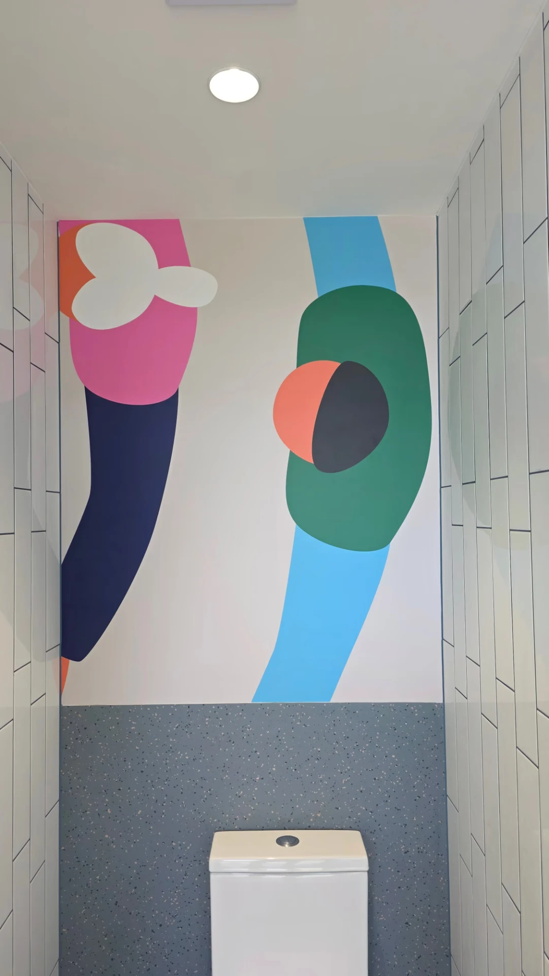 Full height custom printed wall mural with bold overlapping colour shapes in a corridor
