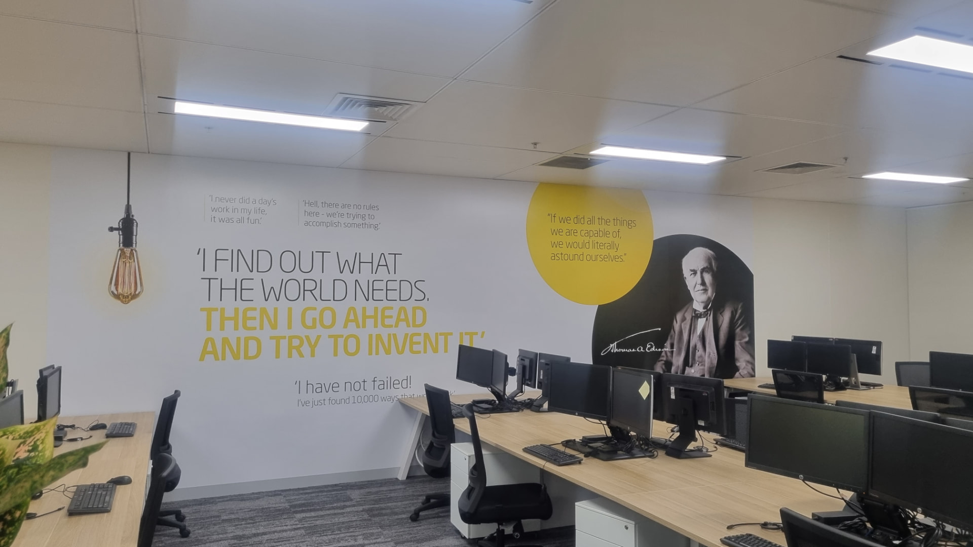 Large custom printed wall graphic with portrait and quote lettering installed in a Melbourne office