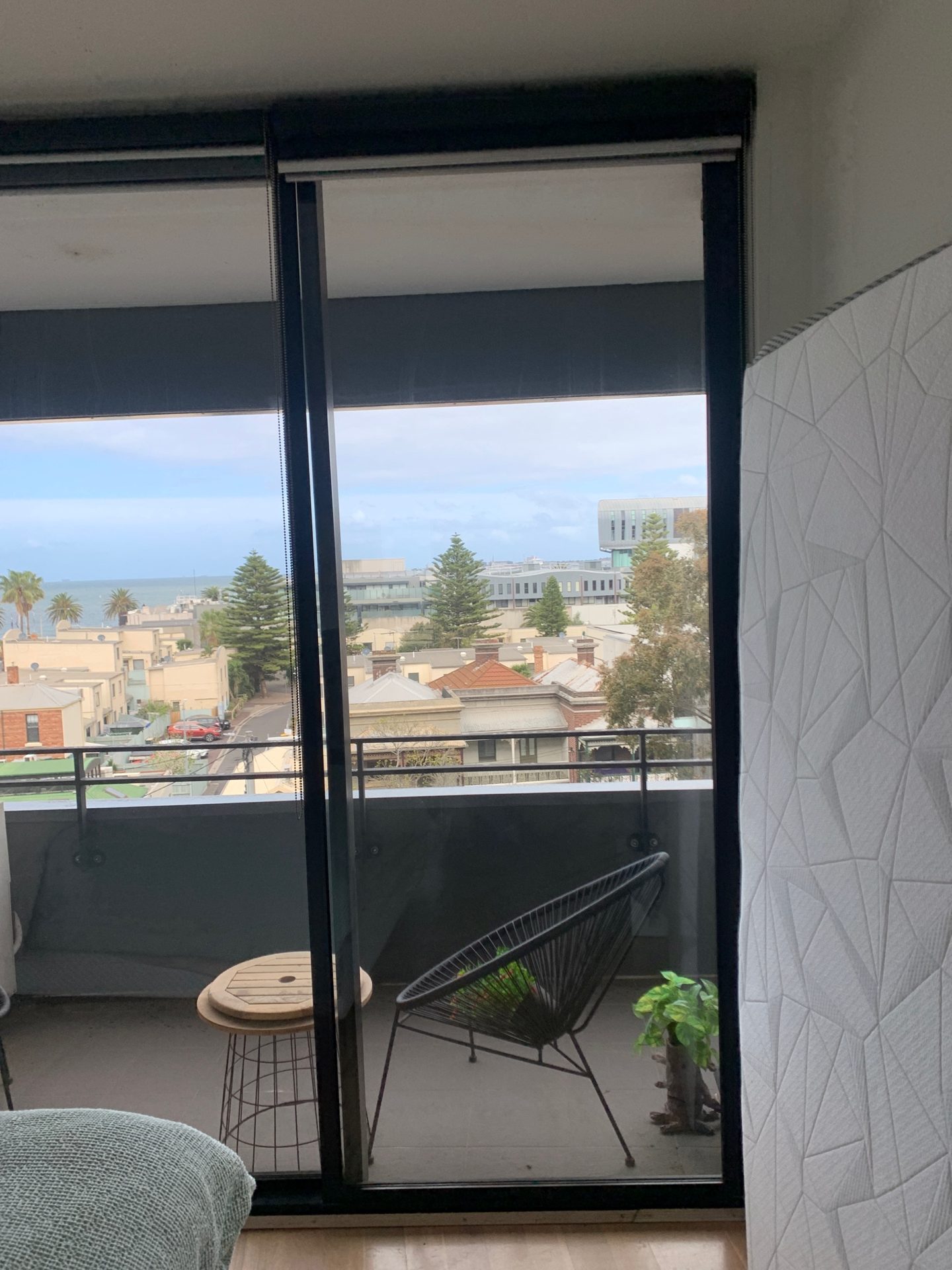 Apartment balcony door glazing with a view over Port Melbourne