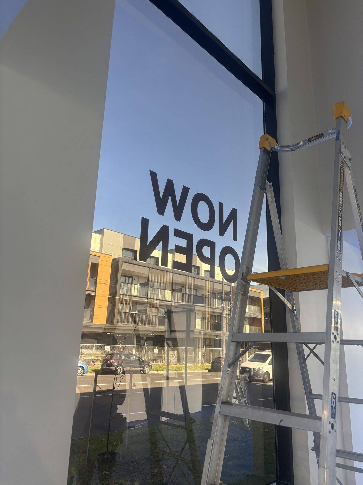 Close-up of completed 3M Ultra S800 security film install on a Melbourne shopfront, optically clear with full street visibility