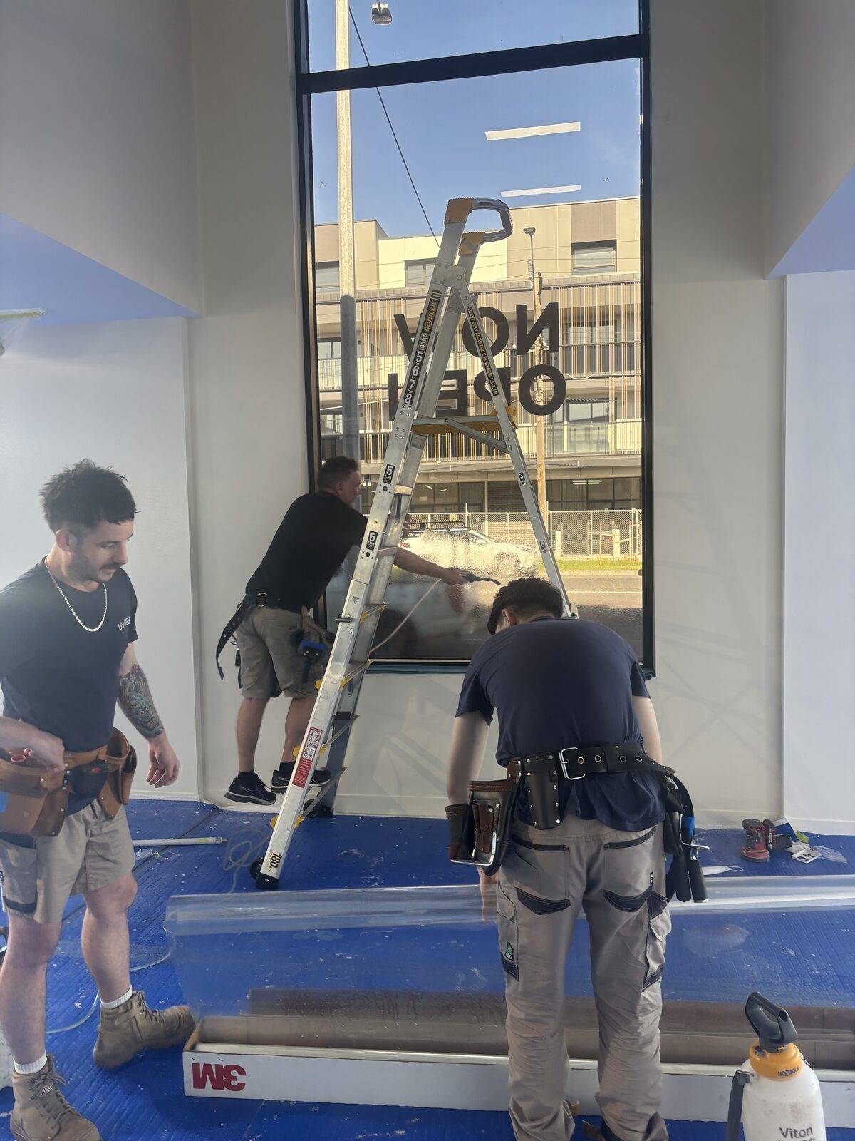 UV Window Coatings team installing 3M Ultra S800 security film on a large Melbourne shopfront window