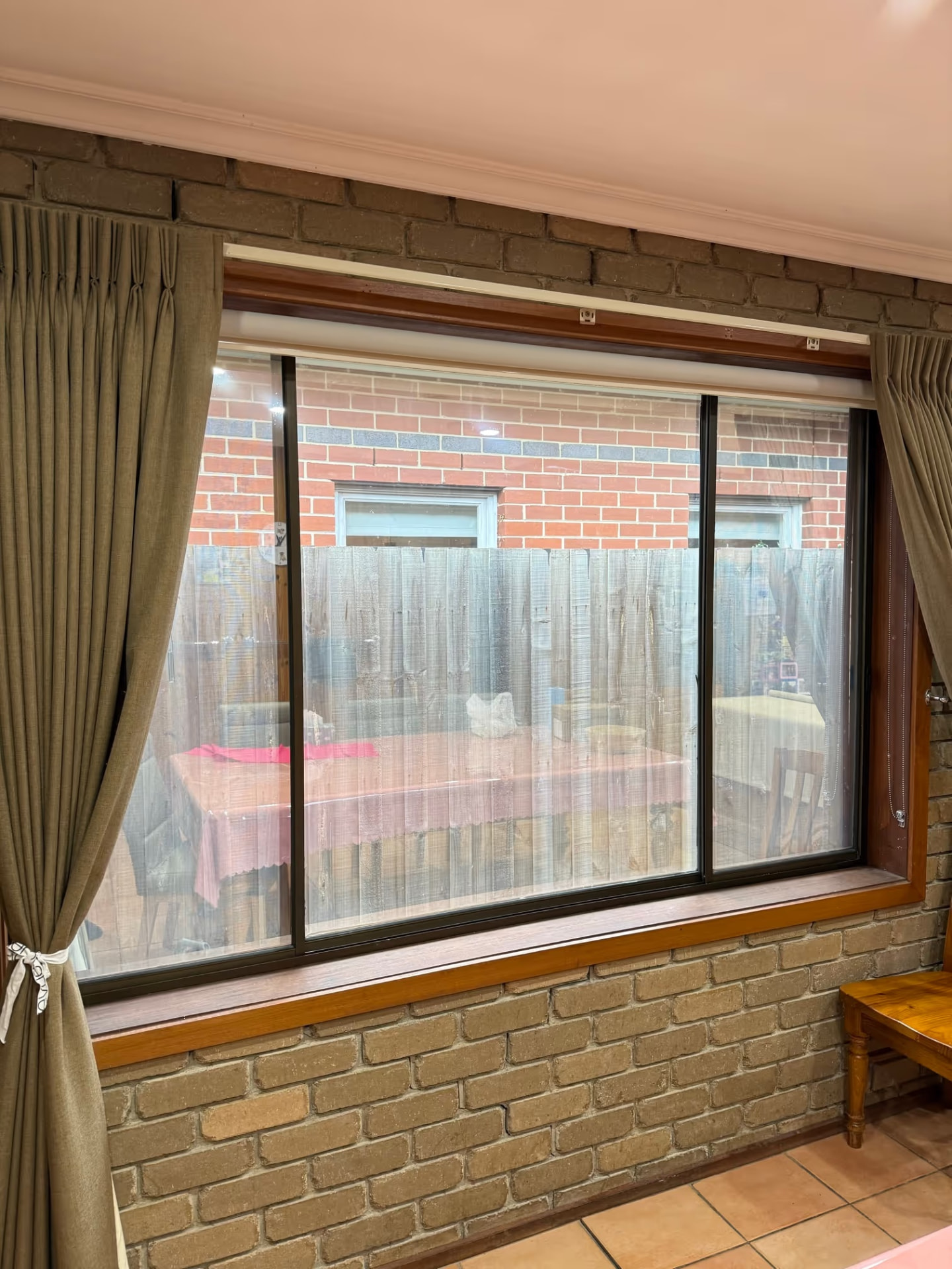 Reflective window film used with curtains and a blind in a Newport home