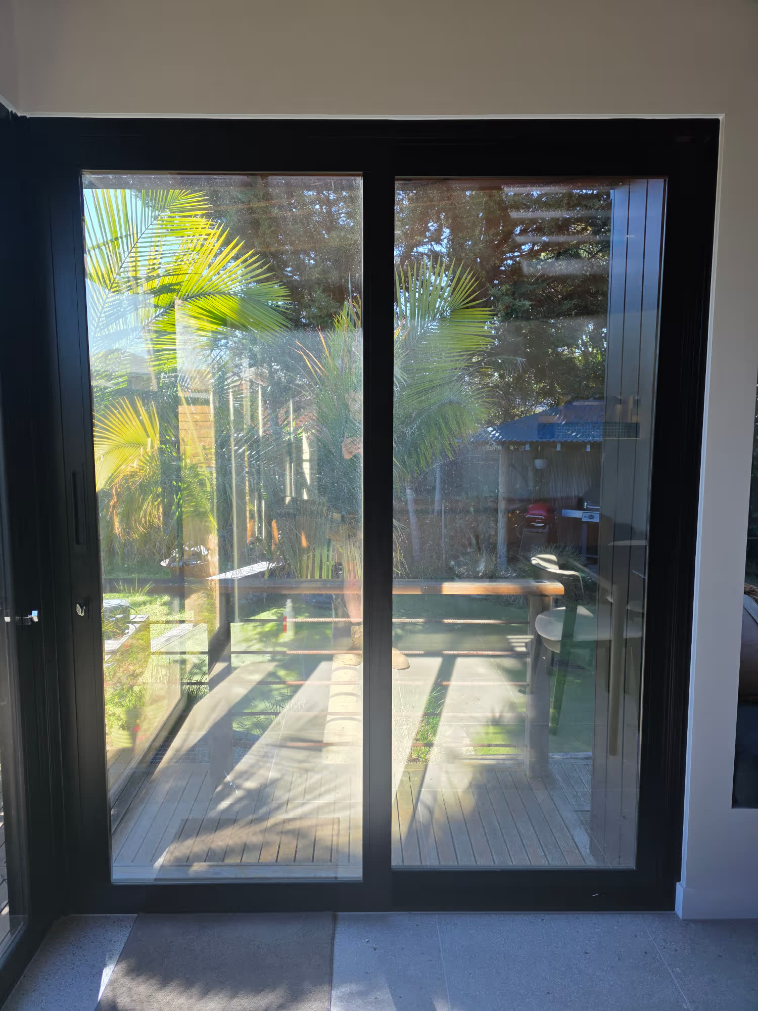 Outward view through Rowville living-area windows treated with All Season LE35