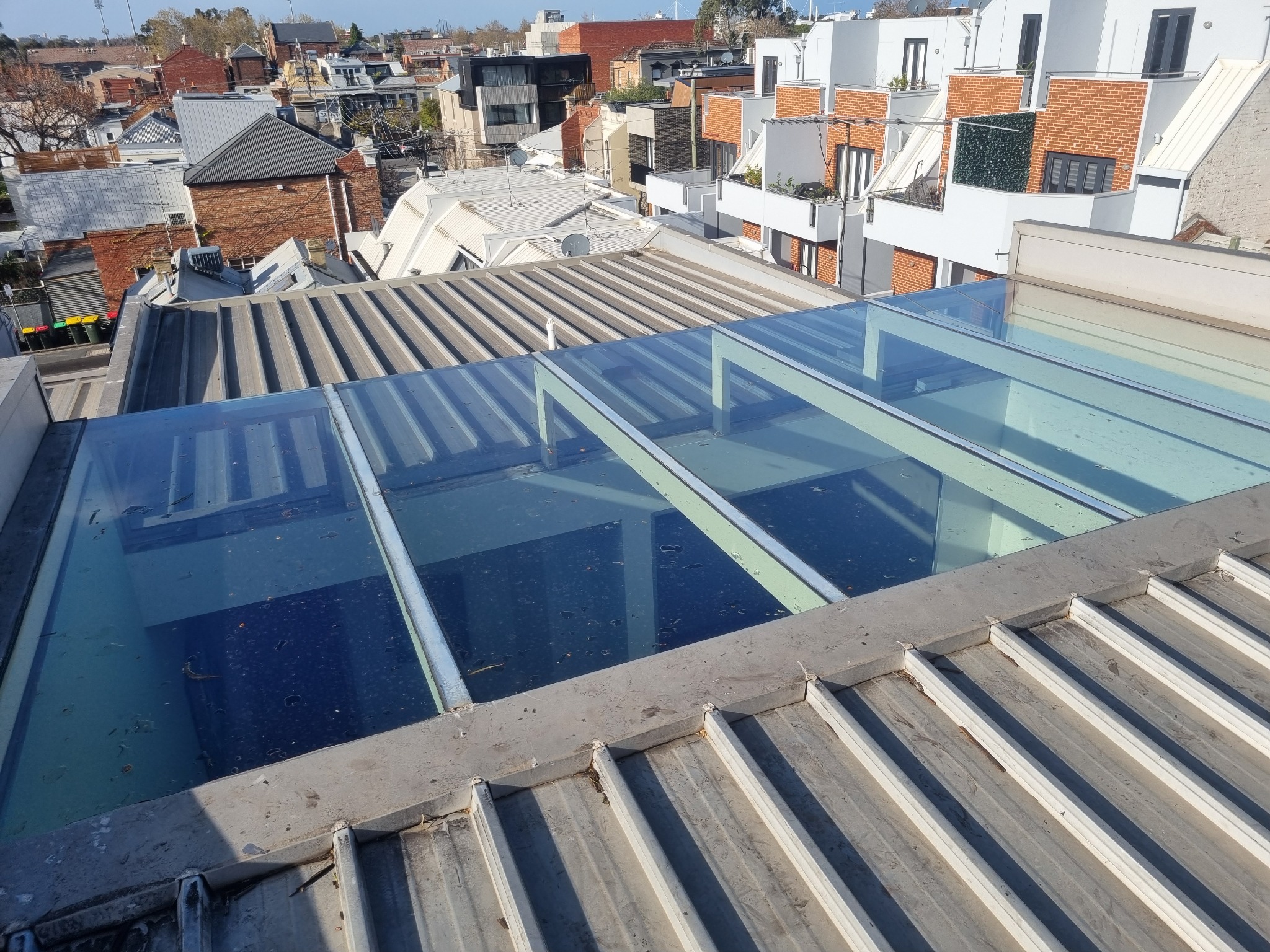 Exterior roof access beside large residential skylight glazing