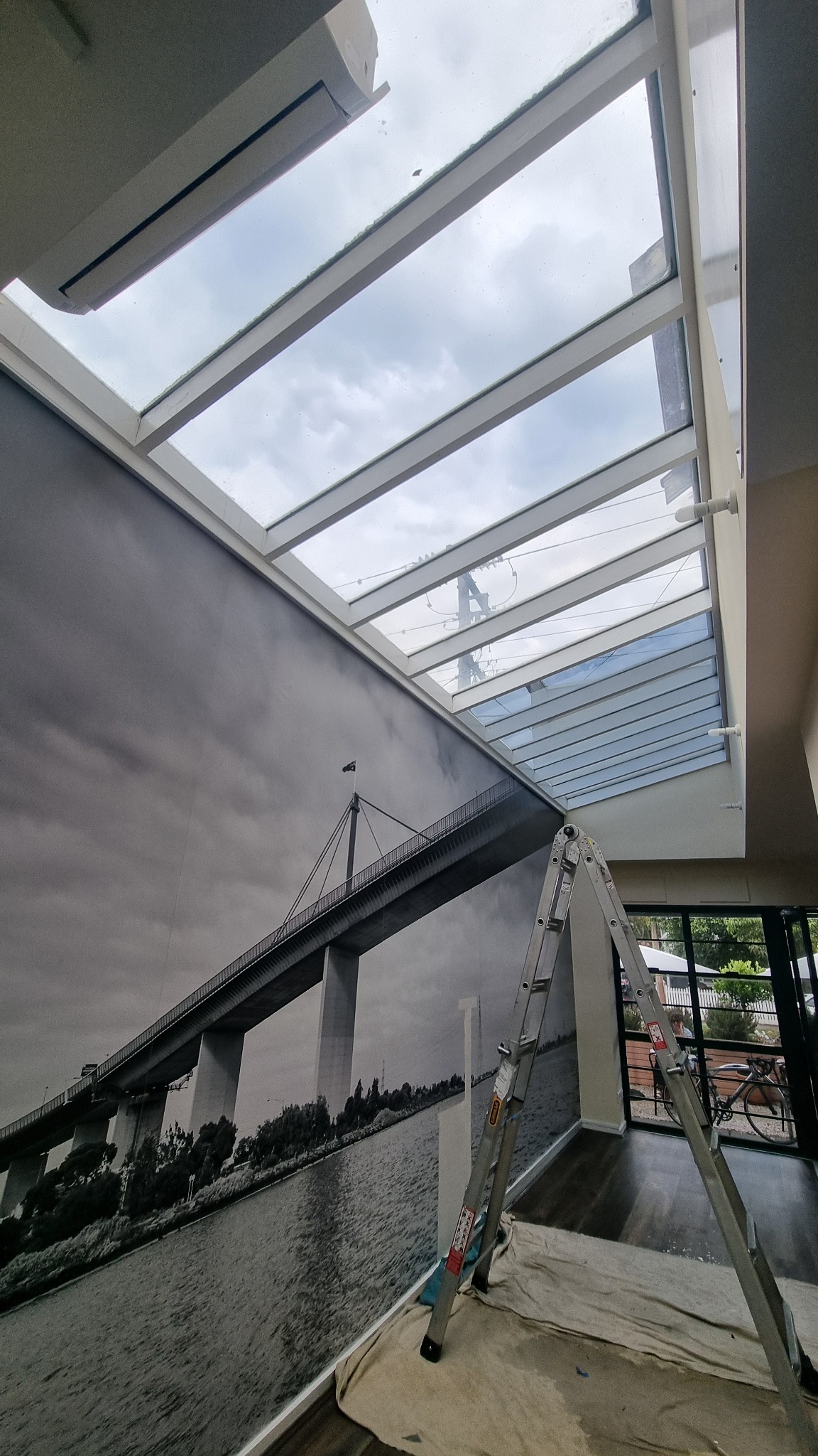 Ladder access below high-level roof glazing for window film installation