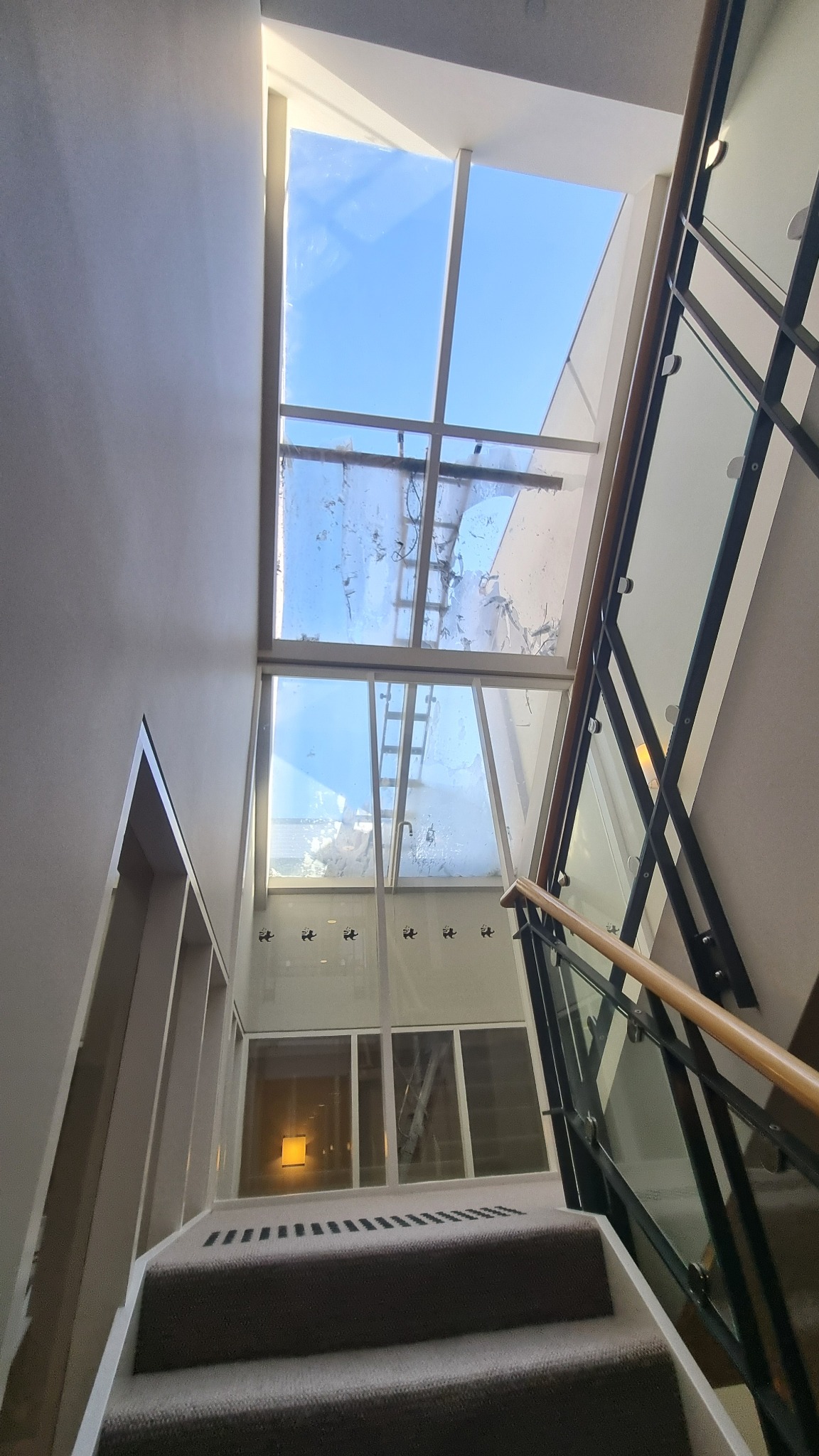 High-level roof glazing above residential stairwell